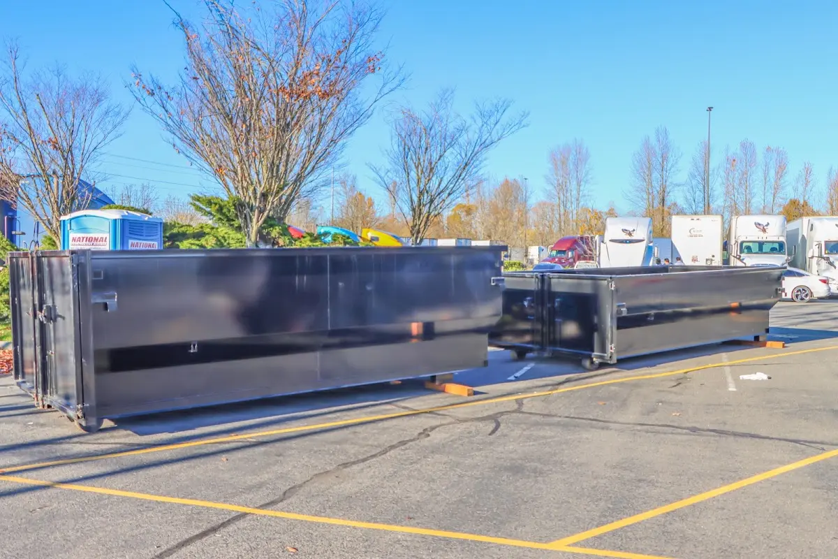 Professional dumpster rental service with roll-off container on residential driveway in North Hempstead